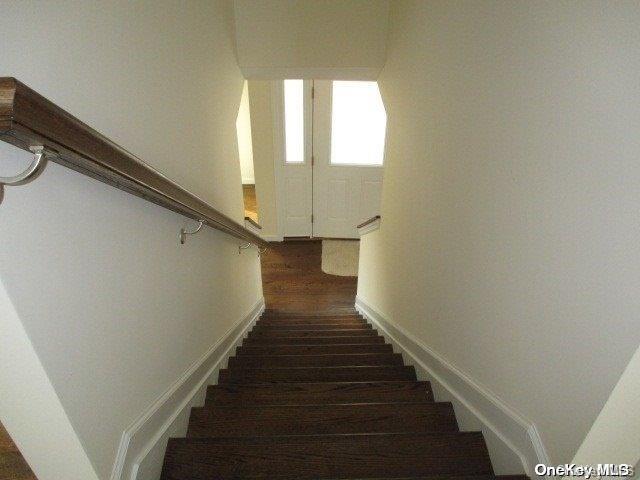 stairs with hardwood / wood-style floors