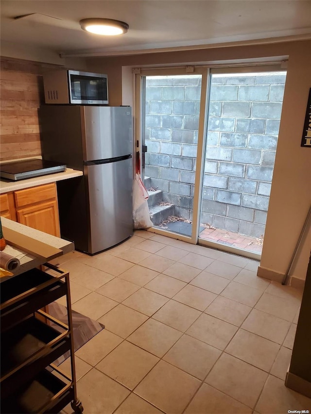 kitchen featuring light tile patterned floors and stainless steel appliances