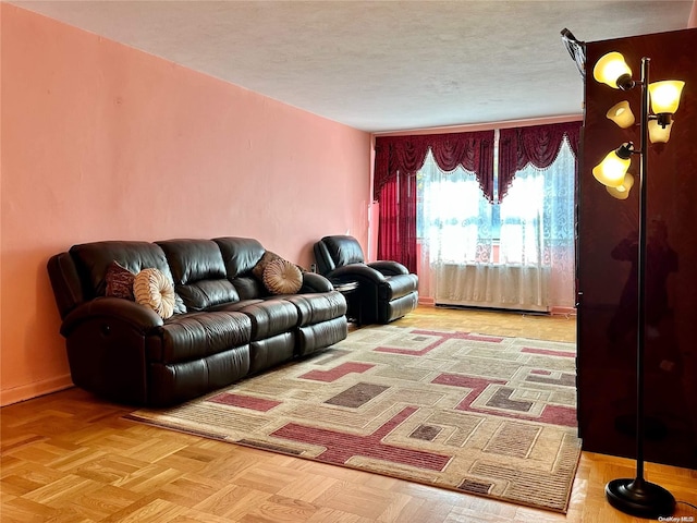 living room featuring parquet floors and a baseboard heating unit