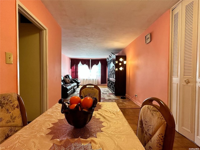 dining room with tile patterned floors and a textured ceiling