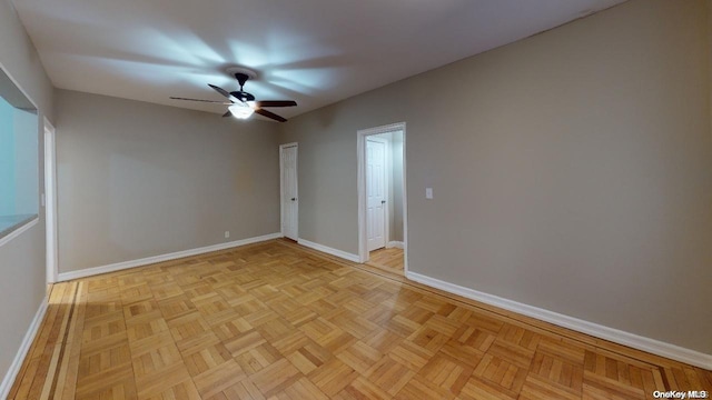 spare room featuring ceiling fan and light parquet flooring