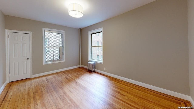 empty room featuring light hardwood / wood-style floors and radiator