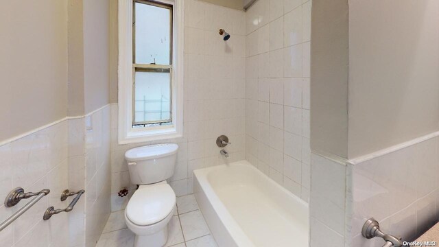 1075 Grand Concourse Unit 3C, Bronx, NY 10452 - full bathroom with toilet, shower / washtub combination, wainscoting, tile walls, and tile patterned floors