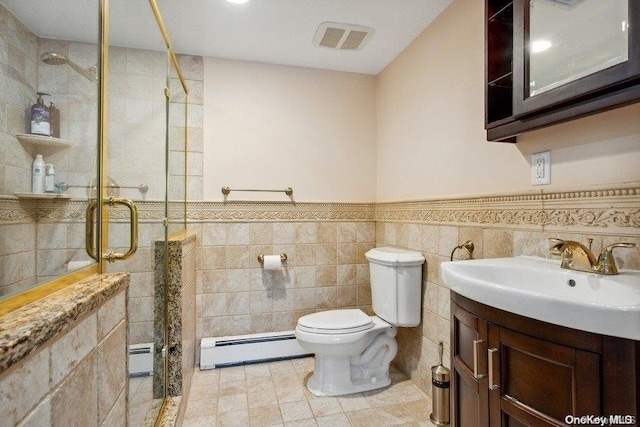 bathroom featuring vanity, a baseboard radiator, toilet, and tile walls