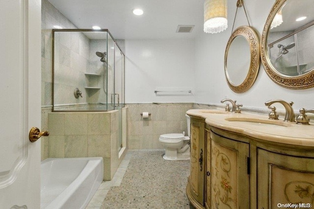 full bathroom featuring vanity, plus walk in shower, tile patterned floors, toilet, and tile walls