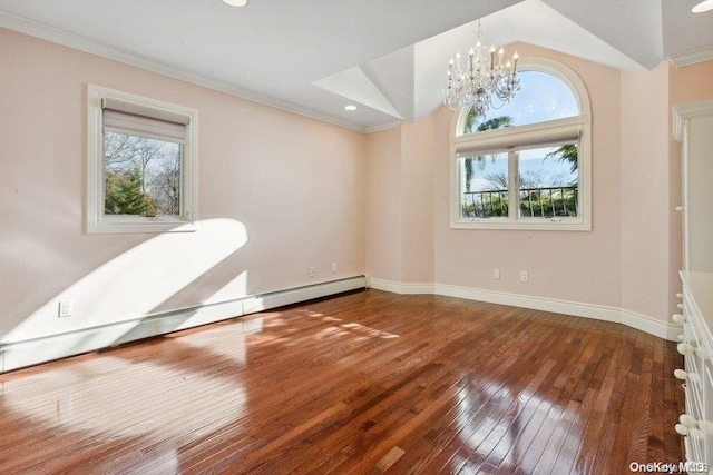 unfurnished room featuring a chandelier, crown molding, wood-type flooring, and a baseboard heating unit