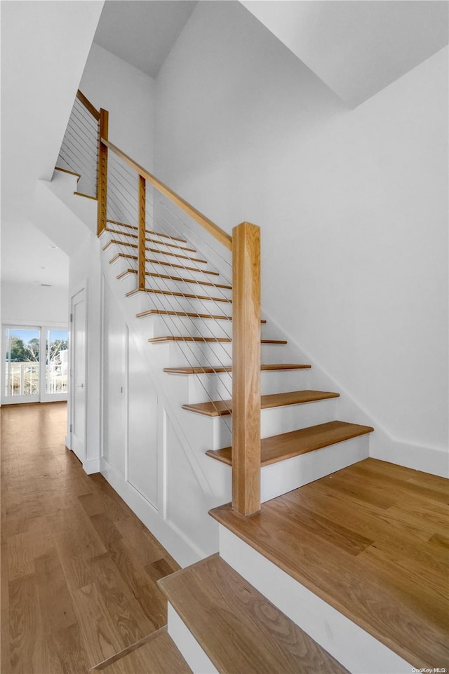 stairway with hardwood / wood-style floors