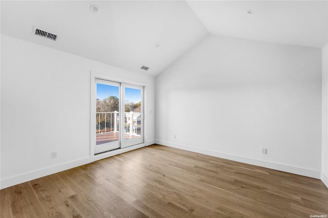 interior space with light hardwood / wood-style floors and vaulted ceiling