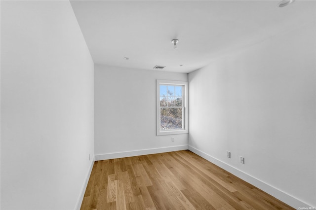 empty room with light hardwood / wood-style floors