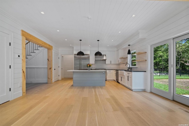 293 Beaver Dam Rd, Brookhaven, NY 11719 - kitchen with open shelves, extractor fan, light wood-type flooring, white cabinetry, and dishwasher