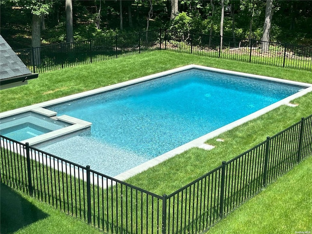 view of swimming pool featuring an in ground hot tub and a lawn