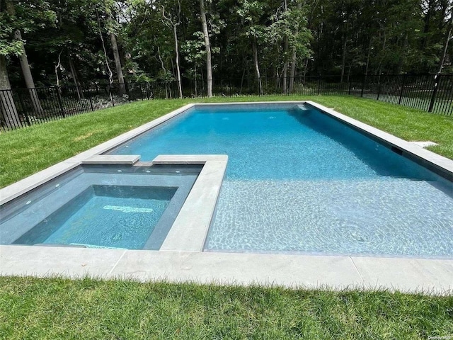 view of swimming pool with an in ground hot tub and a yard