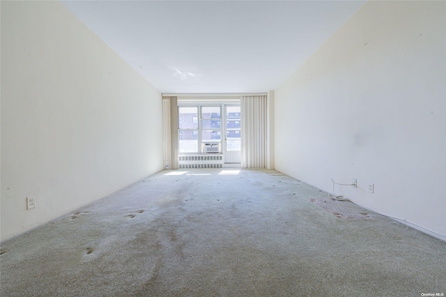 empty room with radiator and carpet