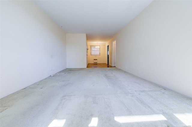 carpeted spare room featuring radiator