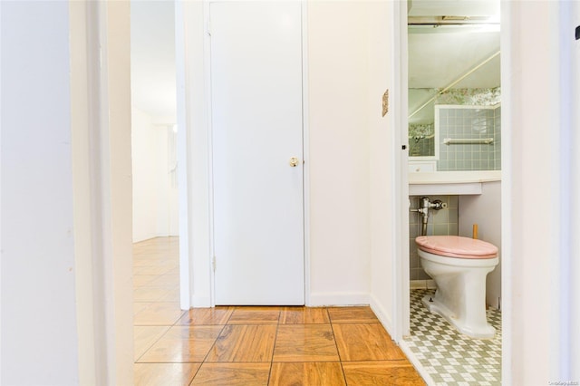 bathroom with tile patterned flooring and toilet