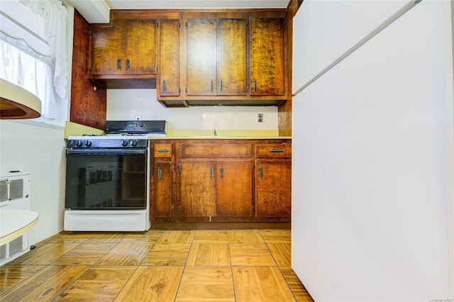 kitchen with sink, white appliances, and ventilation hood