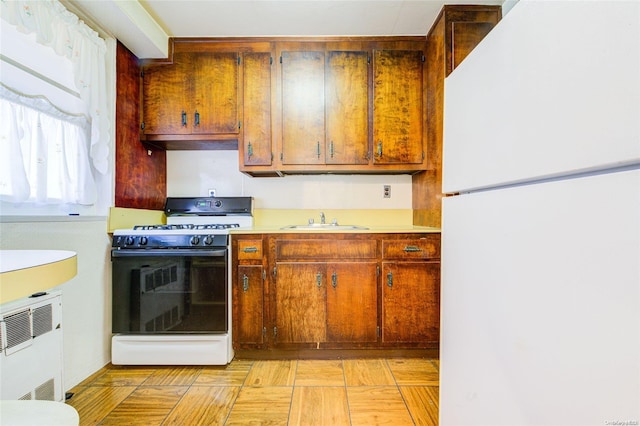 kitchen featuring sink and white appliances