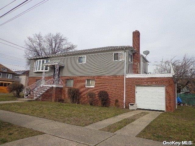 view of home's exterior featuring a garage and a lawn