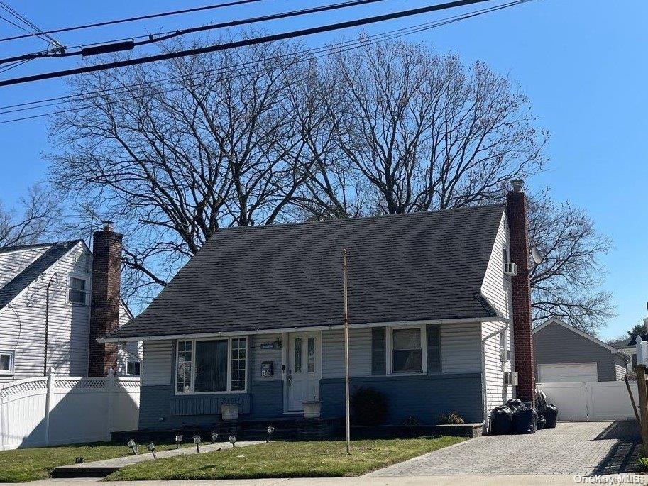 200 Raff Ave, Elmont, NY 11003 - cape cod-style house with a detached garage, an outdoor structure, and a chimney