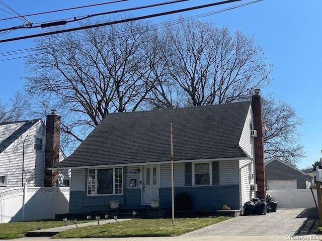 200 Raff Ave, Elmont, NY 11003 - cape cod-style house with a detached garage, an outdoor structure, and a chimney