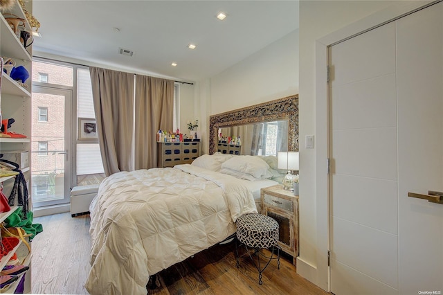 bedroom featuring hardwood / wood-style flooring and multiple windows