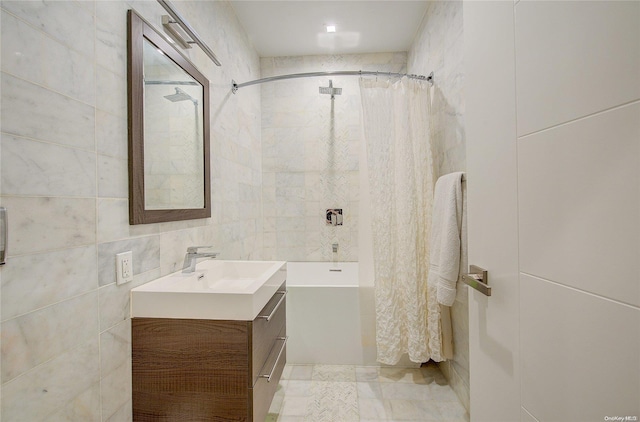 bathroom featuring vanity and tile walls