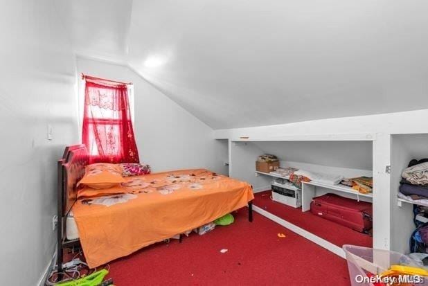 bedroom featuring carpet flooring and vaulted ceiling