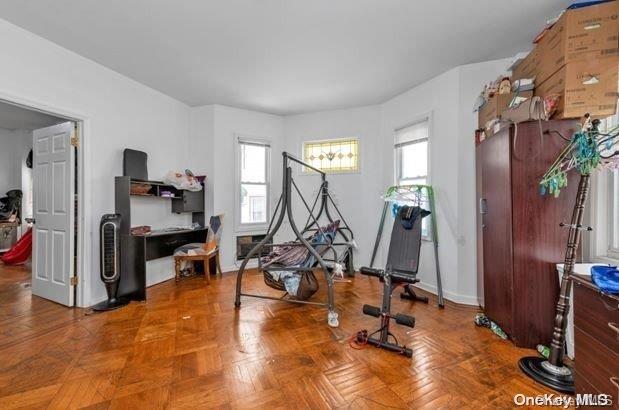 workout room with a wealth of natural light and parquet flooring