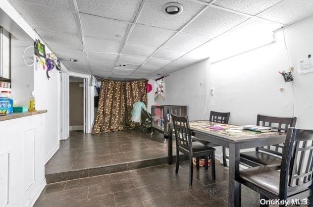 dining area featuring a drop ceiling