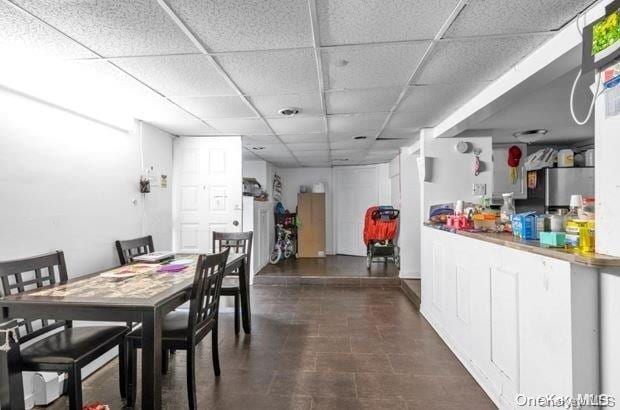 dining space with a paneled ceiling