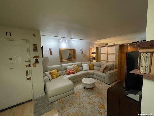 living room with track lighting and light wood-type flooring