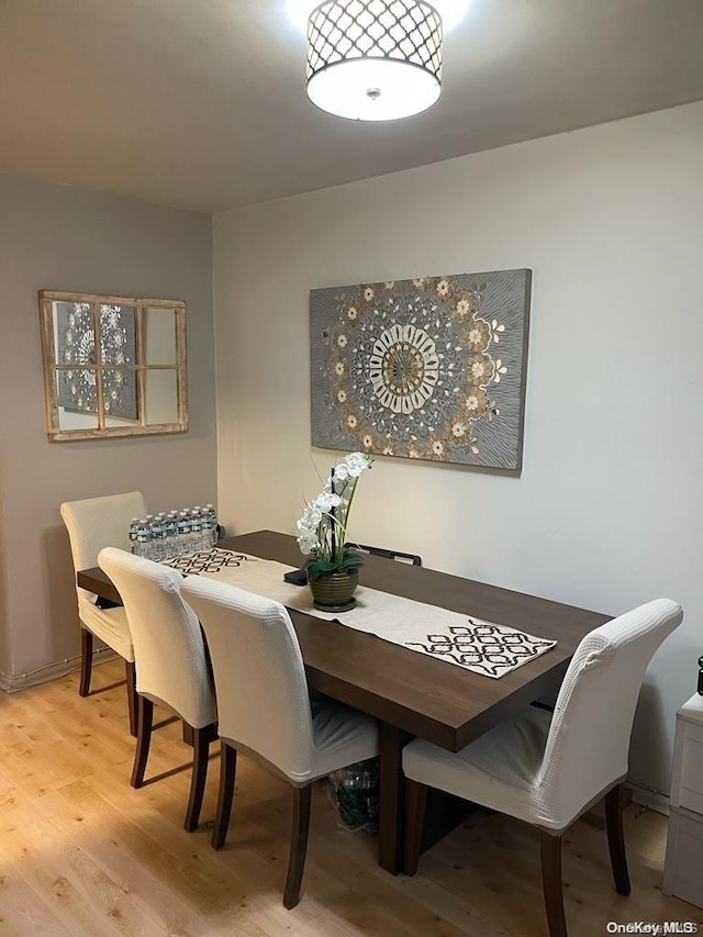 dining space with light hardwood / wood-style flooring