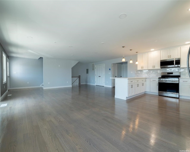 kitchen with backsplash, white cabinets, hanging light fixtures, dark hardwood / wood-style floors, and appliances with stainless steel finishes