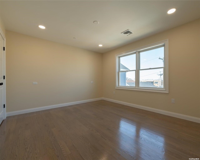 spare room with dark hardwood / wood-style floors