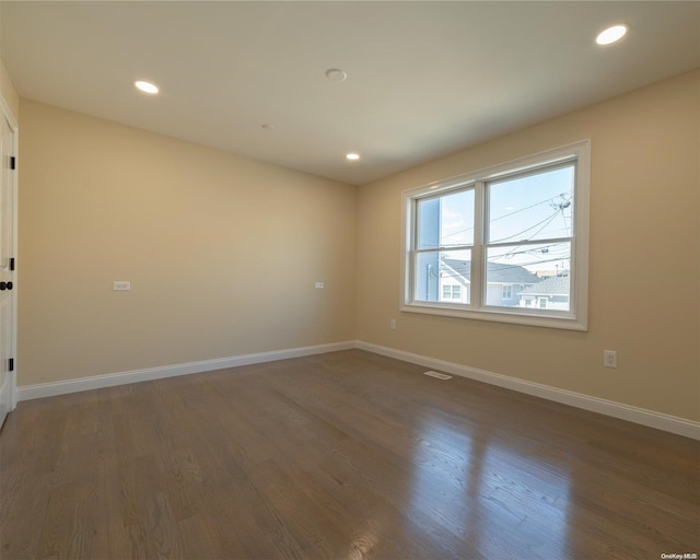 spare room with dark wood-type flooring