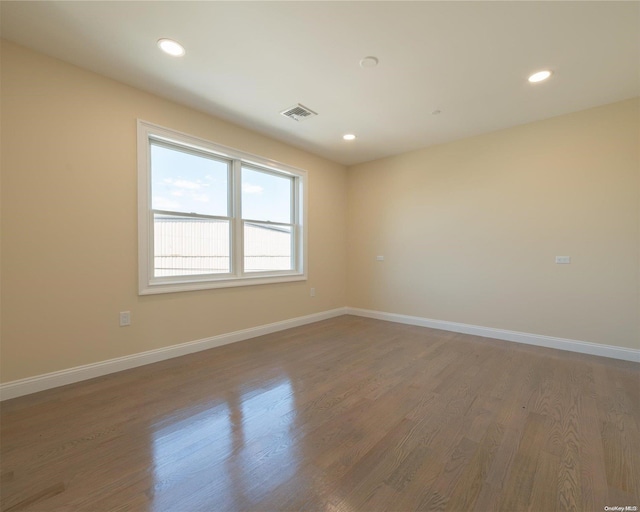 empty room with hardwood / wood-style floors