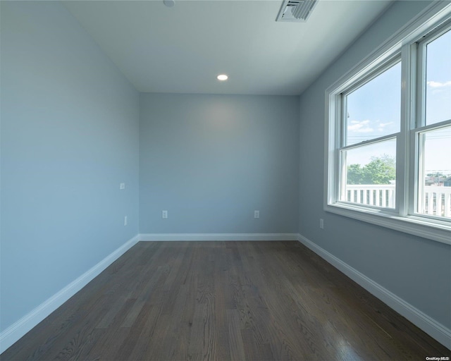 unfurnished room with dark hardwood / wood-style flooring