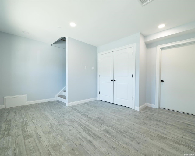 basement featuring light hardwood / wood-style floors