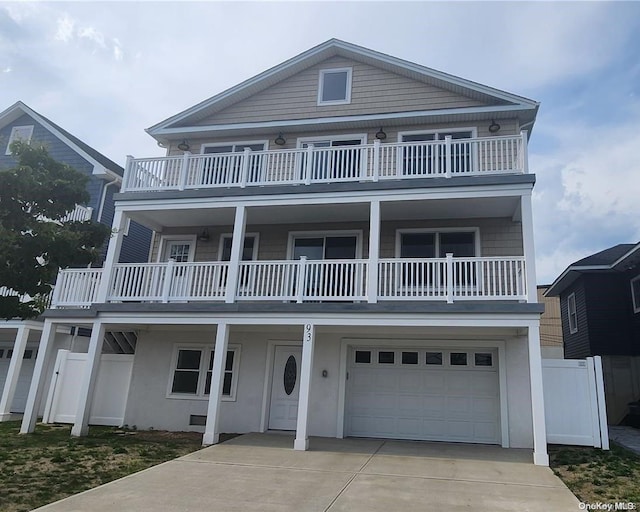 view of front facade with a garage and a balcony