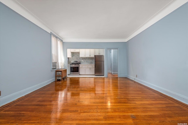 unfurnished living room featuring light hardwood / wood-style flooring and crown molding