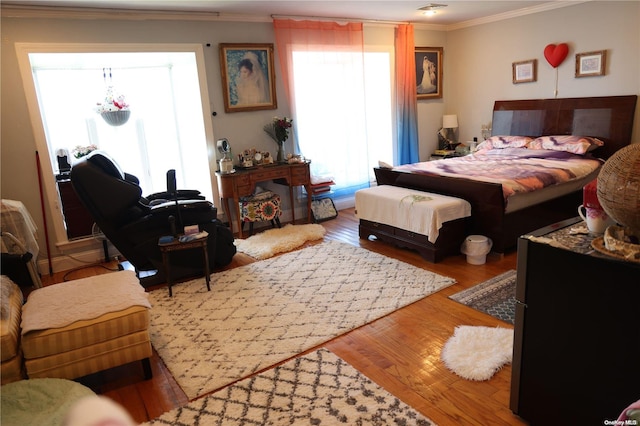 bedroom with wood-type flooring and crown molding