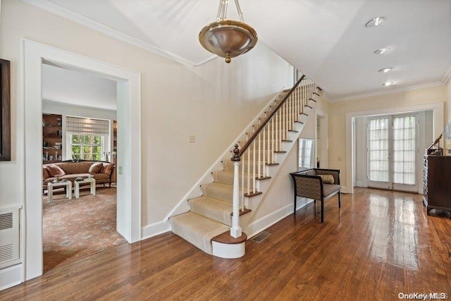 interior space featuring wood-type flooring and ornamental molding