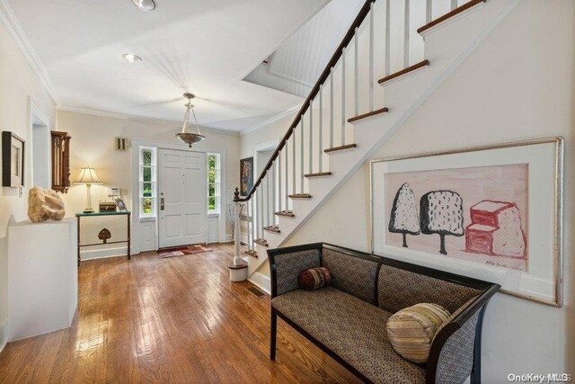 203 Albon Rd, Hewlett Harbor, NY 11557 - entrance foyer with stairway, wood-type flooring, and ornamental molding