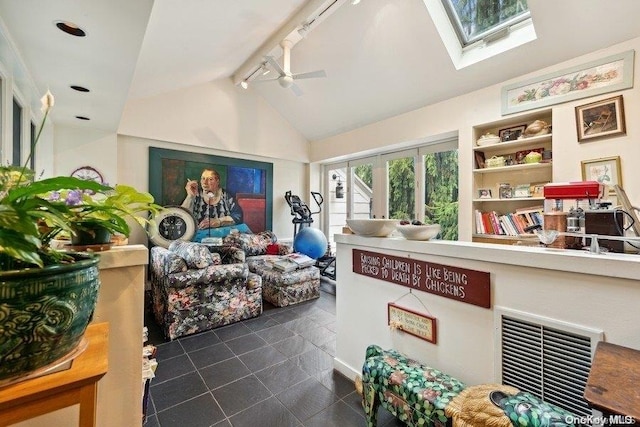 interior space featuring french doors, track lighting, lofted ceiling with skylight, and ceiling fan