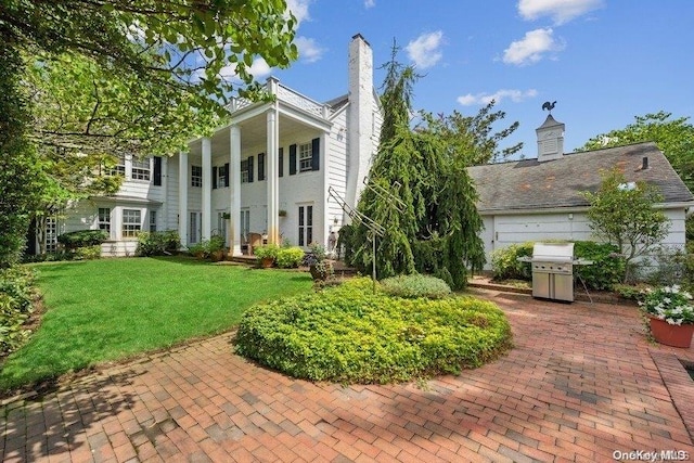 exterior space with a patio area and a front lawn