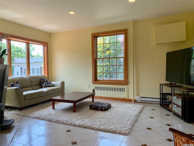 living room with light tile patterned floors, radiator, and a baseboard heating unit