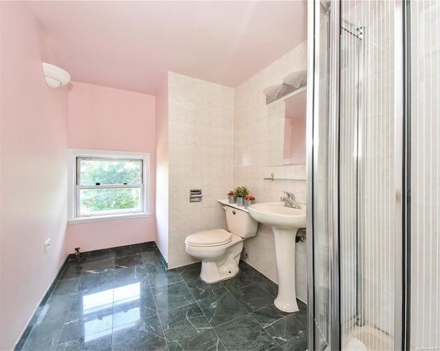 bathroom featuring an enclosed shower, toilet, and tile walls