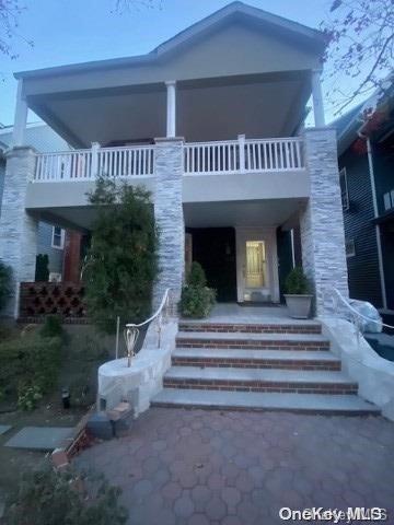 rear view of house with a balcony