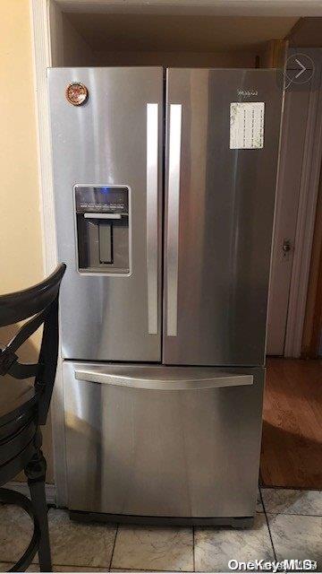 details featuring stainless steel fridge with ice dispenser