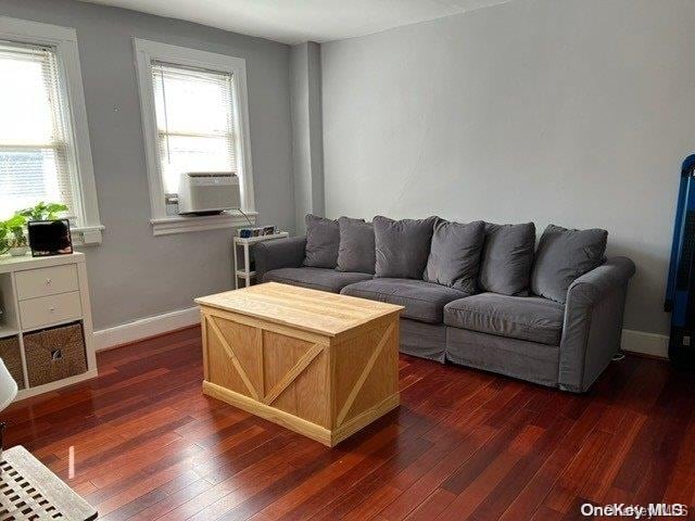 living room with cooling unit and dark hardwood / wood-style floors